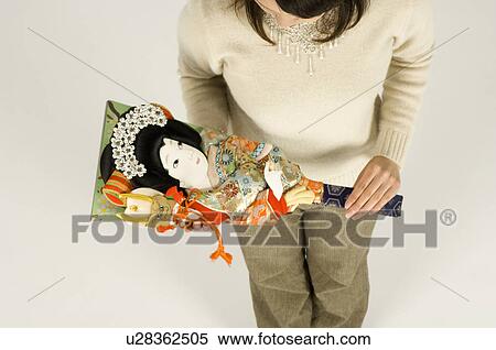 Stock Photography - Young woman holding battledore. Fotosearch