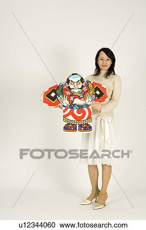 Young woman holding kite View Large Photo Image Stock Image - Young woman holding kite. Fotosearch