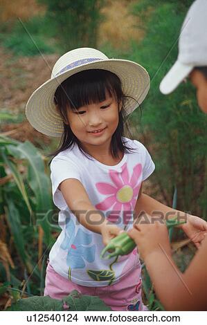 Boy and girl in vegetable garden View Large Photo Image Picture - Boy and girl in vegetable garden. Fotosearch
