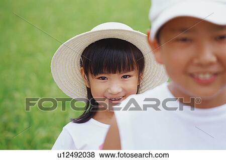 Stock Photo - Boy and girl looking at camera. Fotosearch