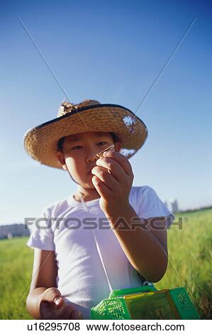 Boy holding grasshopper View Large Photo Image Stock Photo - Boy holding grasshopper. Fotosearch