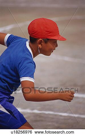 Stock Photograph - Boy in starting position at school sports day. Fotosearch
