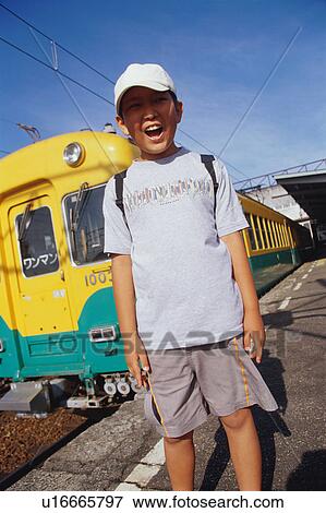 Boy standing at station View Large Photo Image Stock Photo - Boy standing at station. Fotosearch