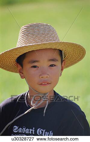 Stock Photo - Boy wearing straw hat. Fotosearch