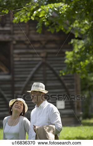 Mature couple walking in park View Large Photo Image Stock Image - Mature couple walking in park. Fotosearch