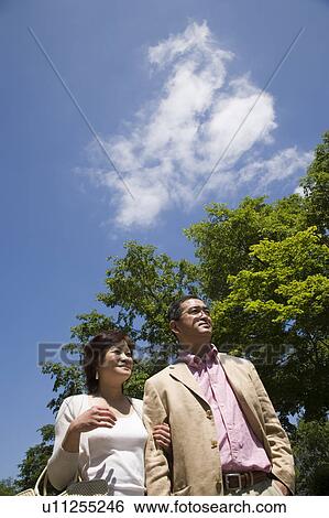 Mature couple walking View Large Photo Image Stock Photograph - Mature couple walking. Fotosearch