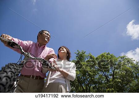 Mature couple with mountain bike View Large Photo Image Stock Image - Mature couple with mountain bike. Fotosearch