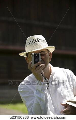 Mature man taking photo View Large Photo Image Stock Photograph - Mature man taking photo. Fotosearch