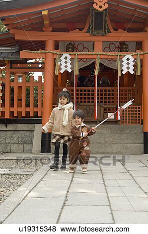 Brother and sister at shrine View Large Photo Image Stock Photo - Brother and sister at shrine. Fotosearch