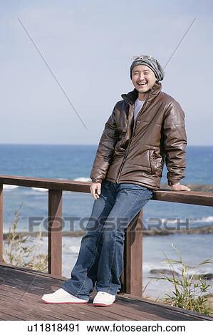 Man standing on boardwalk View Large Photo Image Stock Image - Man standing on boardwalk. Fotosearch