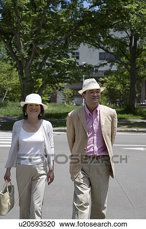Mature couple walking View Large Photo Image Stock Image - Mature couple walking. Fotosearch