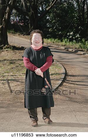 Stock Image - Portrait of a senior woman standing. Fotosearch