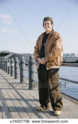 Portrait of a young man smiling View Large Photo Image Stock Photo - Portrait of a young man smiling. Fotosearch