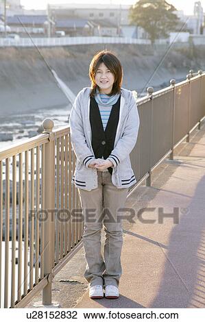 Portrait of a young woman smiling View Large Photo Image Stock Image - Portrait of a young woman smiling. Fotosearch