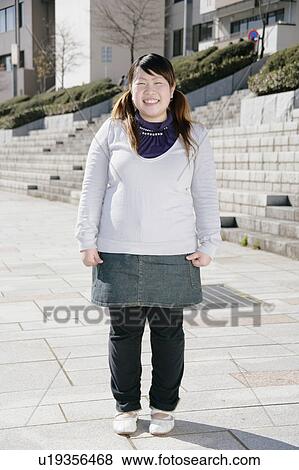 Portrait of a young woman smiling View Large Photo Image Stock Photo - Portrait of a young woman smiling. Fotosearch