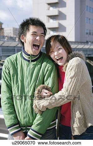 Portrait of young couple laughing View Large Photo Image Stock Image - Portrait of young couple laughing. Fotosearch