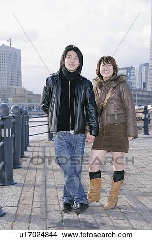 Portrait of young couple standing View Large Photo Image Picture - Portrait of young couple standing. Fotosearch
