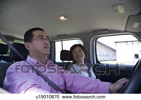 Stock Image - Mature couple in car. Fotosearch