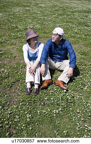 Mature couple sitting on ground View Large Photo Image Stock Photo - Mature couple sitting on ground. Fotosearch
