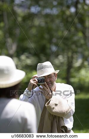 Mature man taking photo of his wife View Large Photo Image Stock Image - Mature man taking photo of his wife. Fotosearch