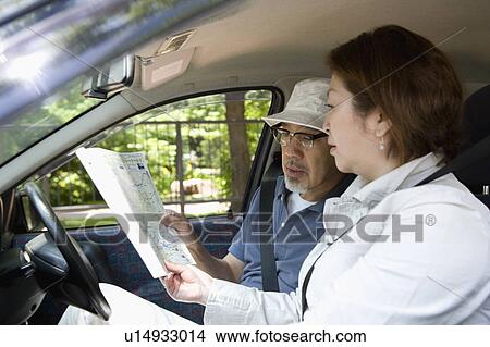 Senior couple looking at map in car View Large Photo Image Picture - Senior couple looking at map in car. Fotosearch