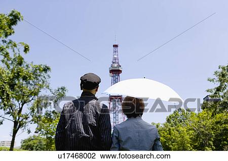 Senior couple looking at tower, rear view View Large Photo Image Stock Image - Senior couple looking at tower, rear view. Fotosearch
