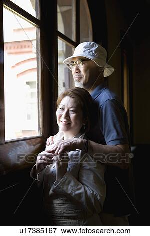 Senior couple looking out window View Large Photo Image Stock Photo - Senior couple looking out window. Fotosearch
