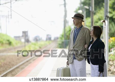 Picture - Senior couple standing at station. Fotosearch
