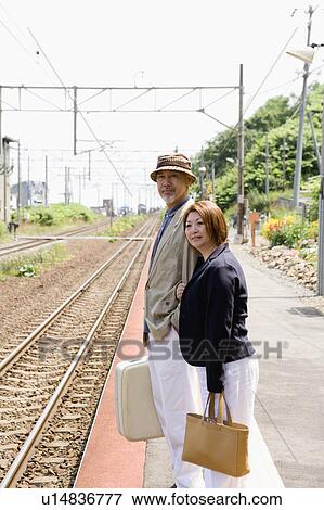 Senior couple standing at station View Large Photo Image Stock Photo - Senior couple standing at station. Fotosearch