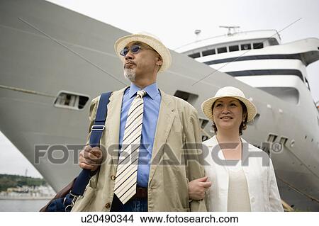 Senior couple standing in front of ship View Large Photo Image Picture - Senior couple standing in front of ship. Fotosearch
