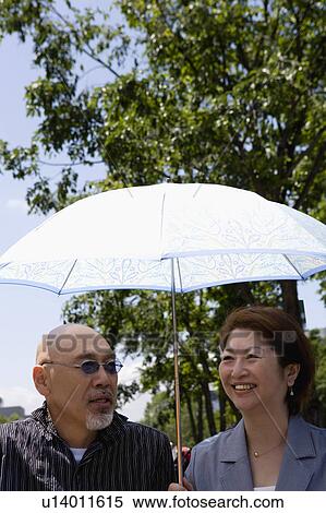 Senior couple under parasol View Large Photo Image Stock Photography - Senior couple under parasol. Fotosearch