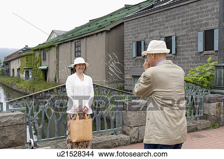 Senior man taking photo of his wife View Large Photo Image Picture - Senior man taking photo of his wife. Fotosearch