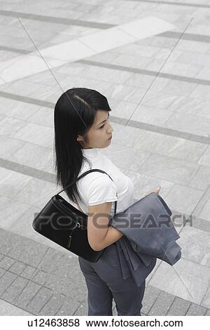 Stock Photo - A high angle view of a woman waiting for someone. Fotosearch