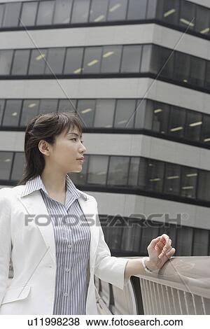 Stock Photo - A woman staring at something during daylight. Fotosearch
