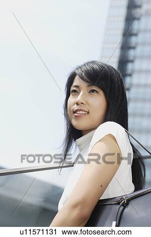 A woman staring at something in bright sunlight View Large Photo Image Stock Image - A woman staring at something in bright sunlight. Fotosearch