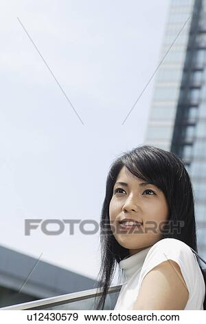 A woman staring at something in bright sunlight View Large Photo Image Stock Photo - A woman staring at something in bright sunlight. Fotosearch