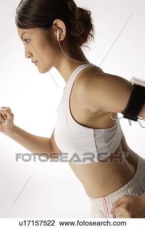 Stock Image - Close-up of a young woman exercising. Fotosearch