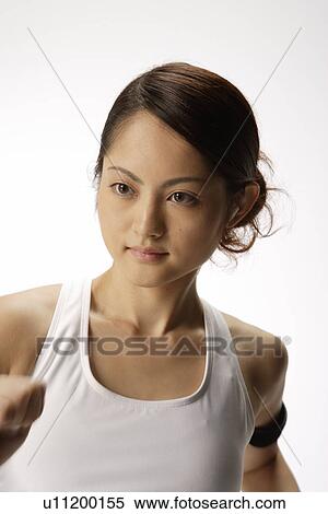 Stock Photography - Close-up of a young woman exercising. Fotosearch