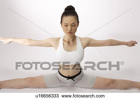 Portrait of a young woman stretching on the floor View Large Photo Image Stock Image - Portrait of a young woman stretching on the floor. Fotosearch