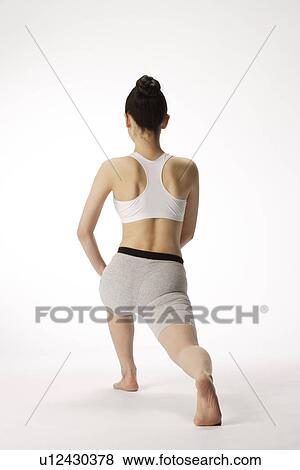 View of a young woman exercising on the floor View Large Photo Image Stock Photo - View of a young woman exercising on the floor. Fotosearch