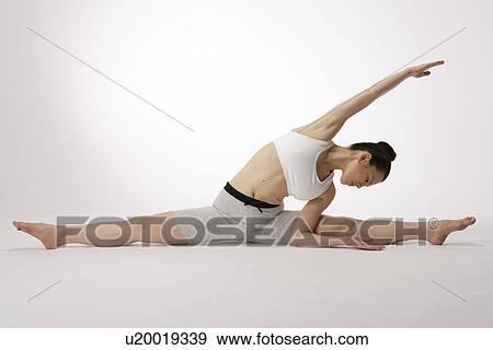 View of a young woman exercising on the floor View Large Photo Image Stock Photo - View of a young woman exercising on the floor. Fotosearch