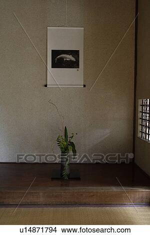 Picture - Front view of a flower vase with a wall hanging. Fotosearch
