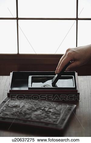 View of a person mixing paint in a box View Large Photo Image Stock Photography - View of a person mixing paint in a box. Fotosearch