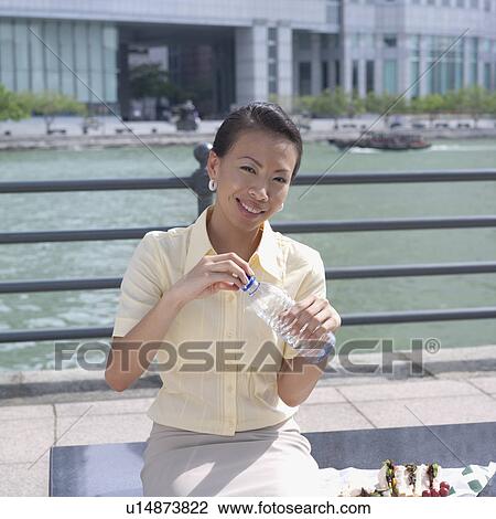 Portrait of a businesswoman holding a water bottle View Large Photo Image Stock Image - Portrait of a businesswoman holding a water bottle. Fotosearch