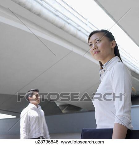 Side profile of a businesswoman holding a briefcase View Large Photo Image Stock Photograph - Side profile of a businesswoman holding a briefcase. Fotosearch