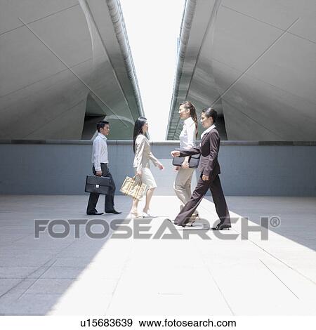 Side profile of three businesswomen and a businessman walking View Large Photo Image Stock Photo - Side profile of three businesswomen and a businessman walking. Fotosearch