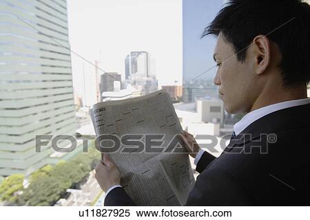 Businessman reading a newspaper, portrait View Large Photo Image Stock Photography - Businessman reading a newspaper, portrait. Fotosearch