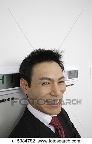 Businessman with time zones, close-up View Large Photo Image Stock Image - Businessman with time zones, close-up. Fotosearch