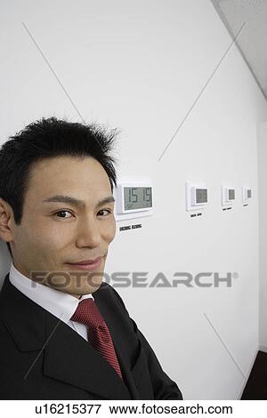 Businessman with time zones, close-up View Large Photo Image Stock Photo - Businessman with time zones, close-up. Fotosearch