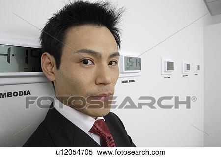 Businessman with time zones, close-up View Large Photo Image Stock Photography - Businessman with time zones, close-up. Fotosearch